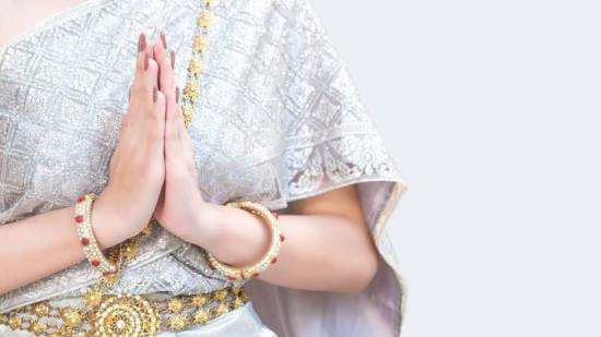 Hands pressed together in a traditional Thai wai greeting
